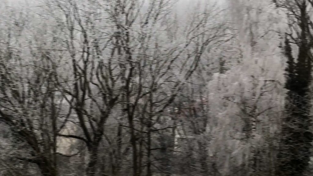 Train window still from Between Windows